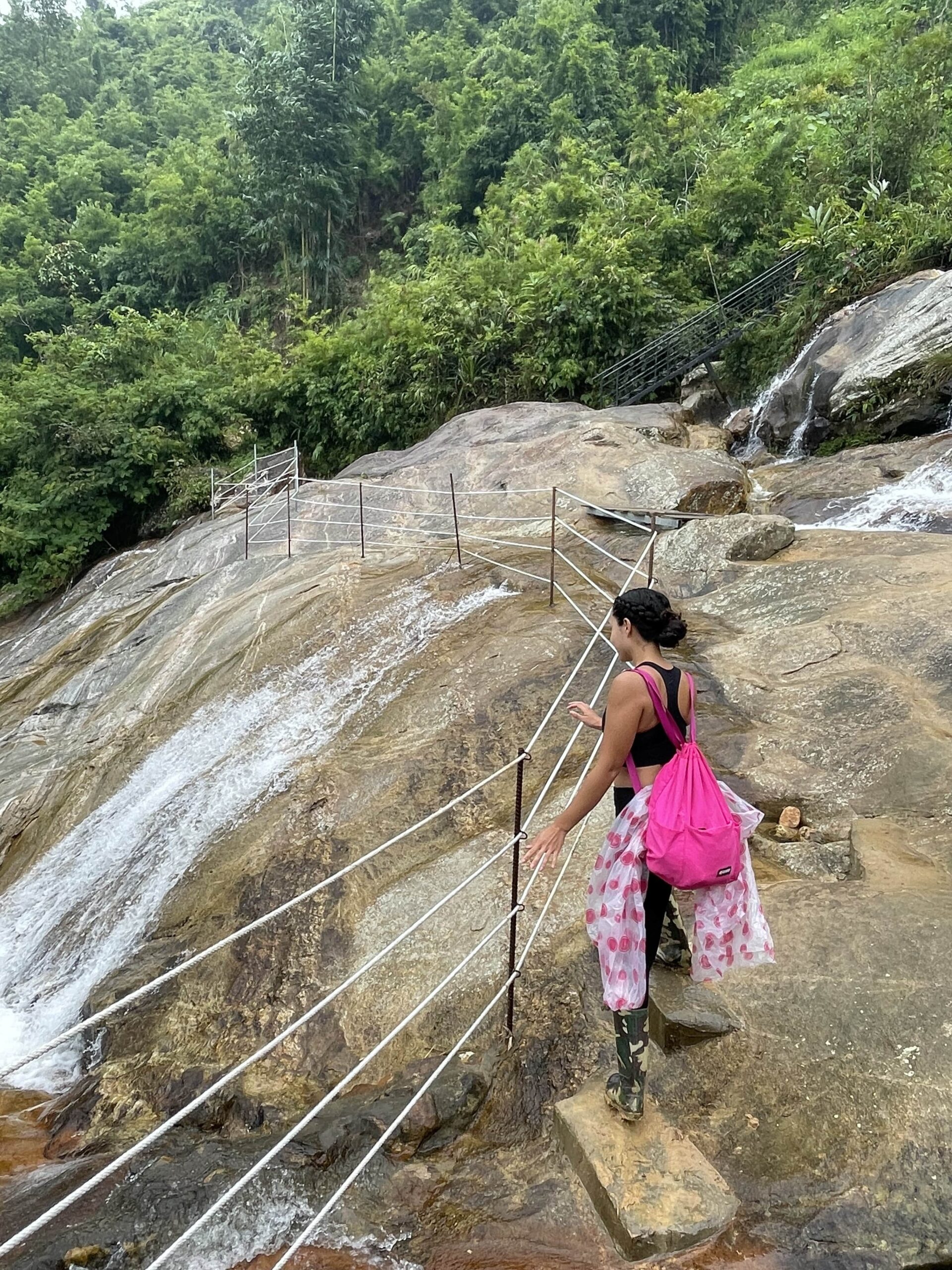 Me as a solo female traveler trekking Sa Pa, Vietnam with my Poncho and pink drawstring day bag