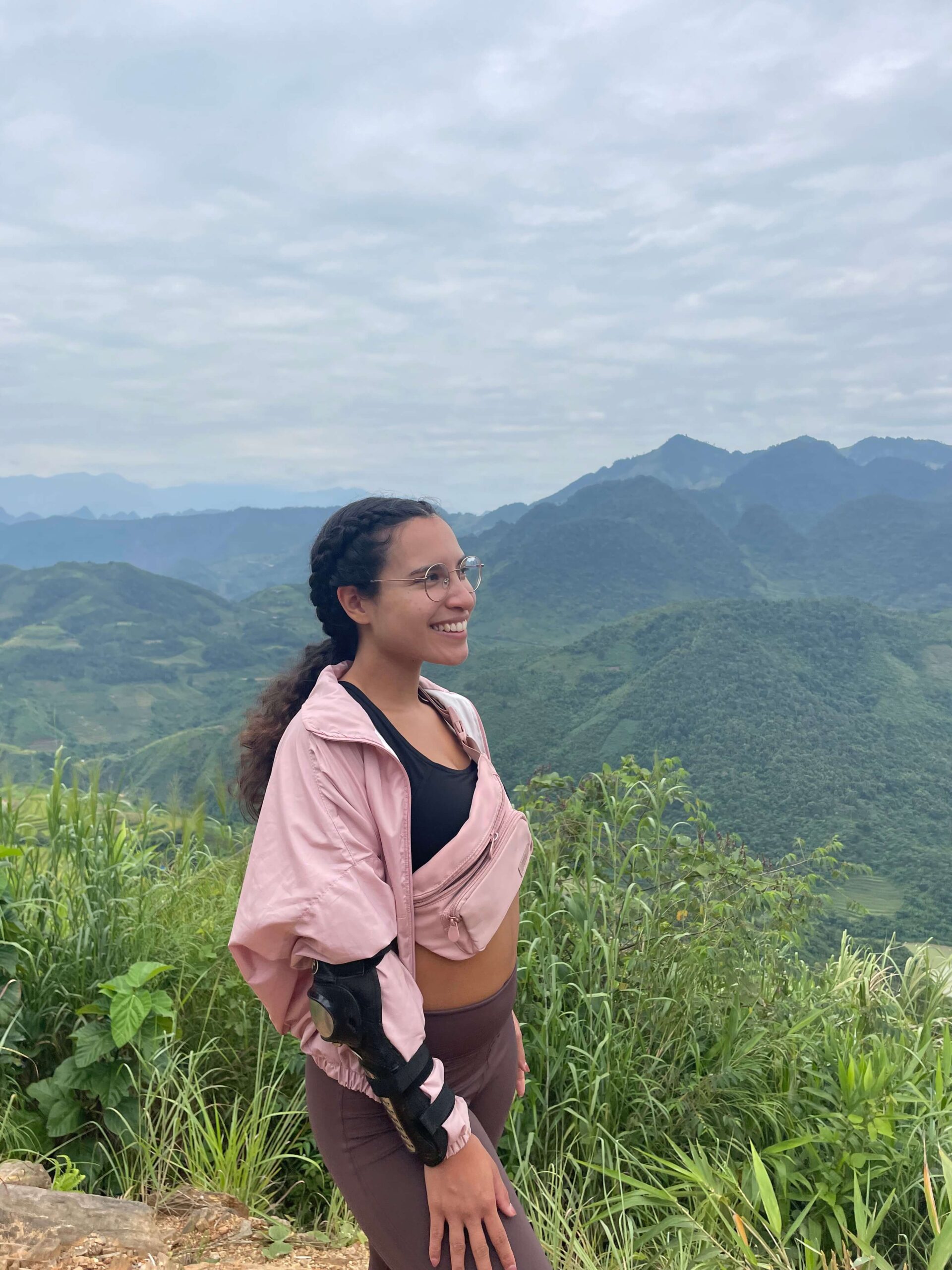 Me as a solo female traveler completing the Ha Giang loop while wearing my pink belt bag/ fanny pack