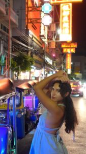 solo female traveler posing while standing in the streets of china town in bangkok thailand during her 1 month in Thailand Itinerary