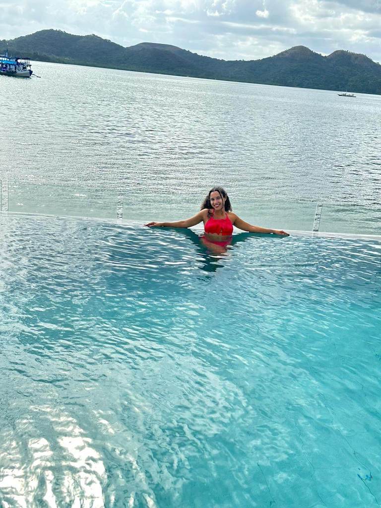 solo female traveler in infinity pool at the Two Seasons Bayside Hotel in Coron, Philippines