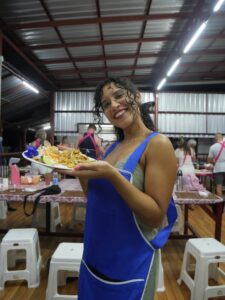 Solo female traveler cooking pad thai during her thai cooking class in chiang mai thialand