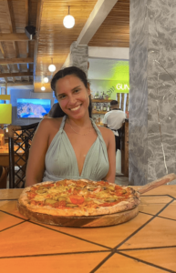 solo female traveler enjoying her dinner at her hostel in puerto princesa, philippines