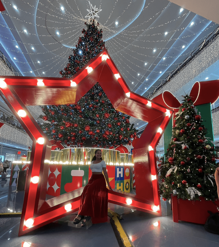 Solo female traveler exploring SM mall of asia and taking advantage of holiday photo opportunities