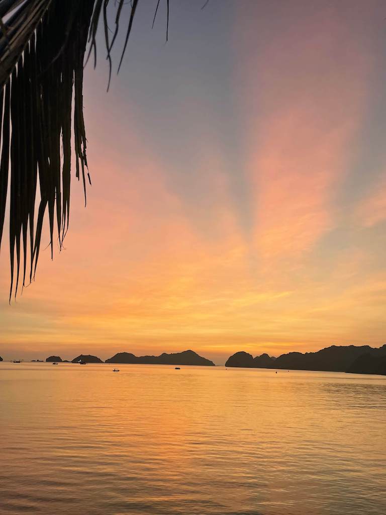 Beautiful sunset at Cat Ba Pier, with colors of pink, orange, and yellows painting the sky